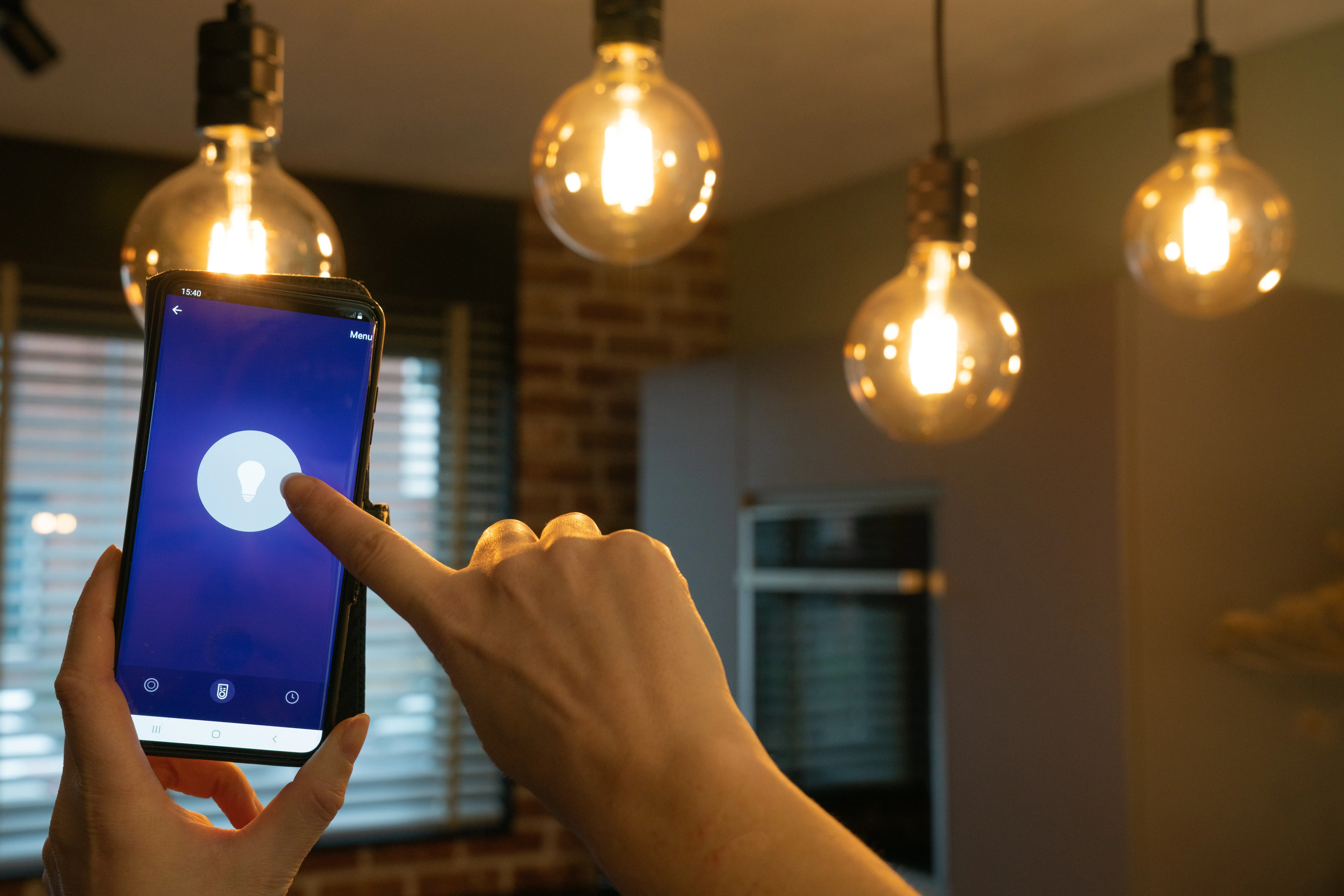 Smart Home. Hand Controlling Smart Lamps With App On The Phone.
